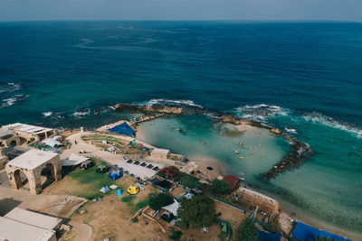 High angle view of swimming pool by sea against sky