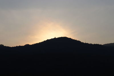 Silhouette mountain against sky during sunset