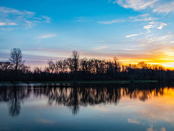 Scenic view of lake against sky during sunset