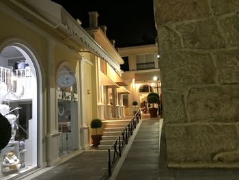 Narrow walkway along buildings at night