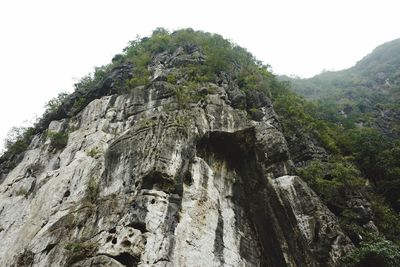 Low angle view of rock formation on mountain against sky