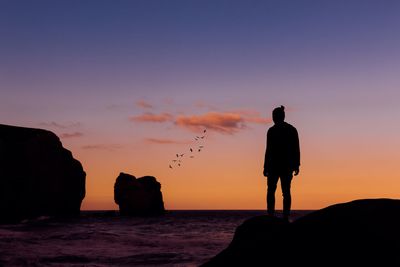 Silhouette man standing on beach