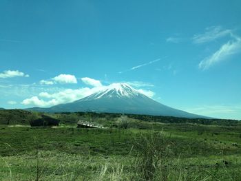 Scenic view of snowcapped mountains against blue sky