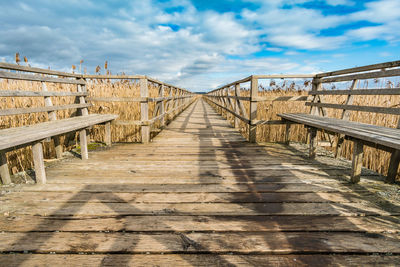 Empty footbridge against sky