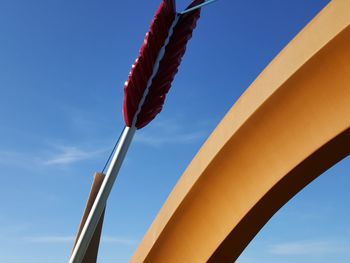 Low angle view of flags against blue sky