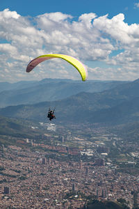 Aerial view of person paragliding against sky