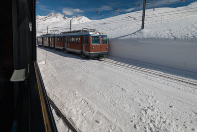 A train of traditional track railway gornergratbahn in the swiss ski region of zermatt in winter