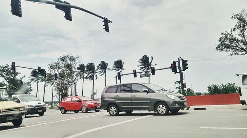 Cars on road against sky