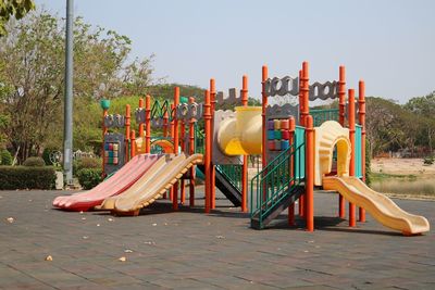 Playground in park against clear sky