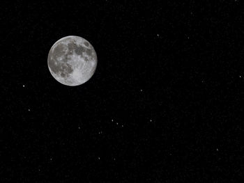 Low angle view of moon against sky at night