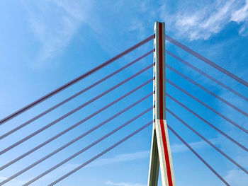 Low angle view of suspension bridge against sky