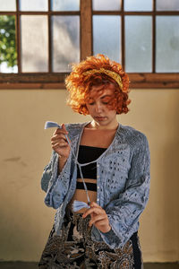 Young alternative redhead girl in a blue blouse