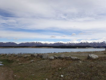 Scenic view of lake and mountains against sky