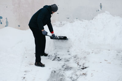 Low section of man skiing on snow