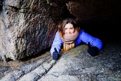 Portrait of happy woman showing thumbs up sign in cave