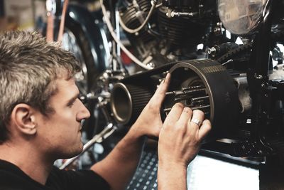 Close-up of man photographing in factory