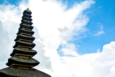 Low angle view of pagoda against cloudy sky