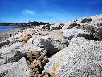 Rocks on beach against sky