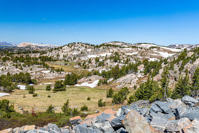 Scenic view of mountains against clear blue sky