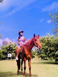 Full length of man riding horse against sky