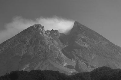 Low angle view of snowcapped mountains against sky