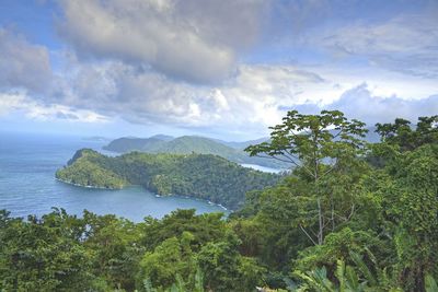 Scenic view of sea and mountains against sky