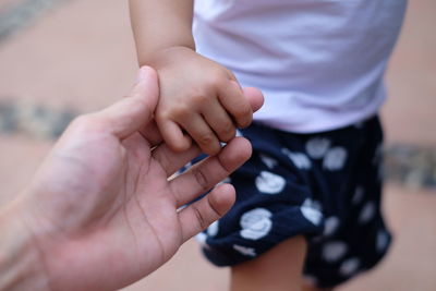 Close-up of couple holding hands