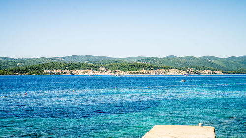 Swimming pool against clear blue sky