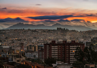 Aerial view of cityscape against sky during sunset