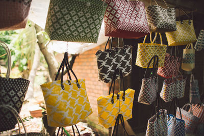 Colorful purses hanging at market