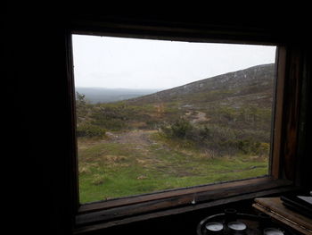 Scenic view of landscape seen through train window