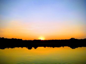 Scenic view of lake against romantic sky at sunset