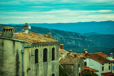 Historic building by mountains against sky