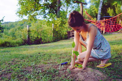 Full length of woman gardening on land