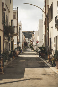 Street amidst buildings in city against sky