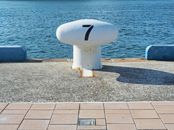 High angle view of stop sign by sea