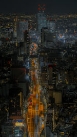 High angle view of illuminated city buildings at night