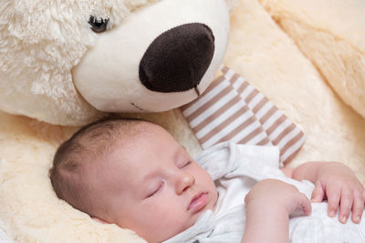 Cute baby girl sleeping on bed