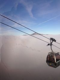 Overhead cable car against sky