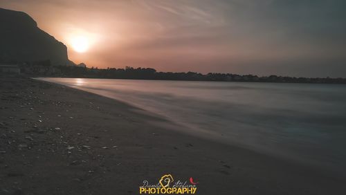 Scenic view of beach against sky during sunset