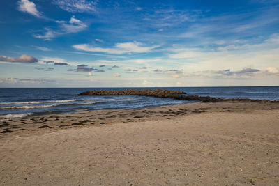 Scenic view of beach against sky during sunset