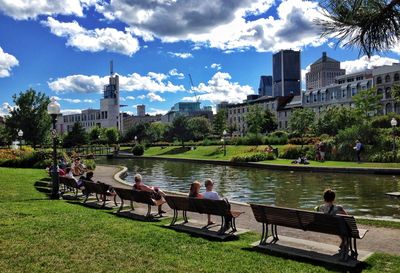 Tourists sitting on riverbank