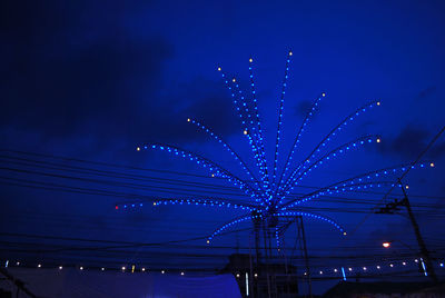 Low angle view of illuminated ferris wheel at night