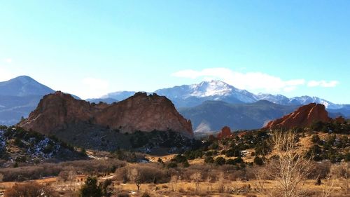 Tranquil view of landscape and rocky mountains against sky