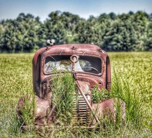 Abandoned car on field