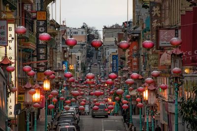 Chinese lantern hanging over street amidst buildings in city