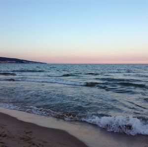 Scenic view of sea against clear sky during sunset