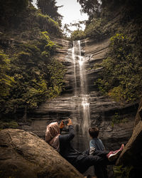 People at waterfall in forest