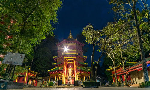 Illuminated building against sky at night