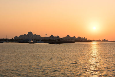 Scenic view of sea against orange sky